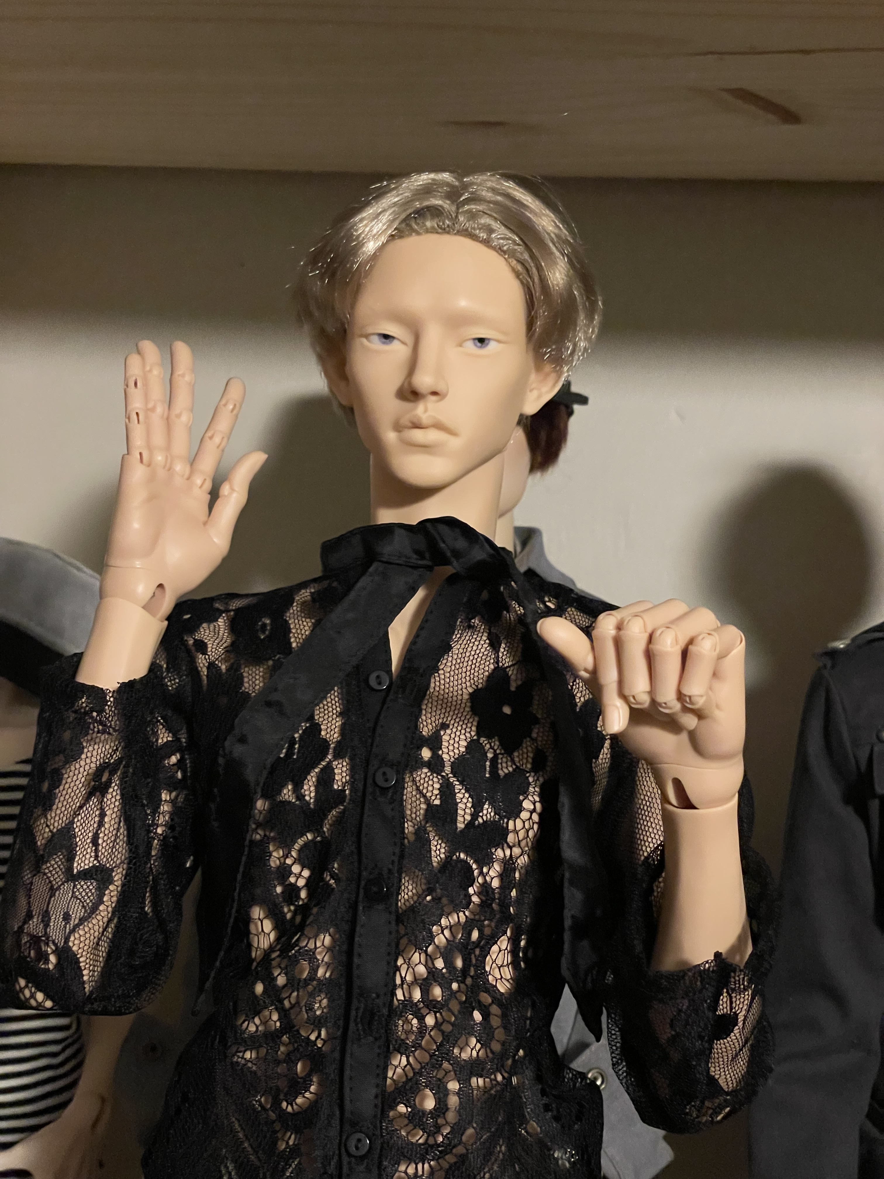 A tan male doll with blond hair