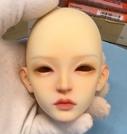 A female dollhead partially painted